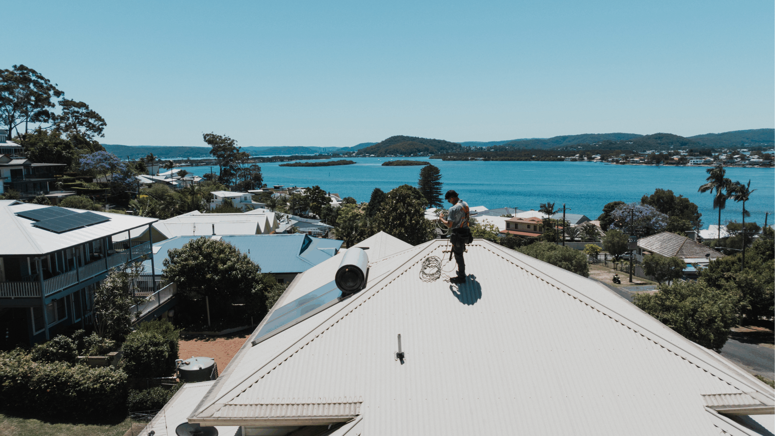 Roof plumber inspecting a Sydney home roof for leaks and storm damage